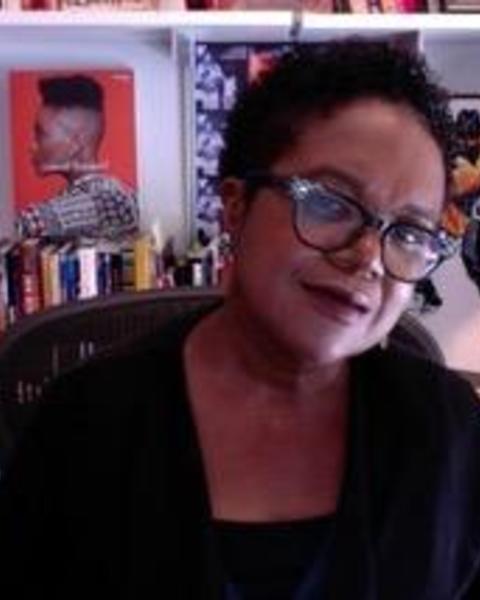 Image of Dr. Marcyliena Morgan in front of a bookshelf